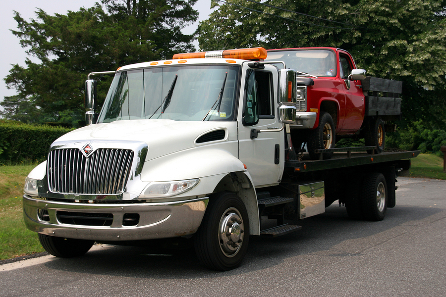 This is a picture of a flatbed truck towing.